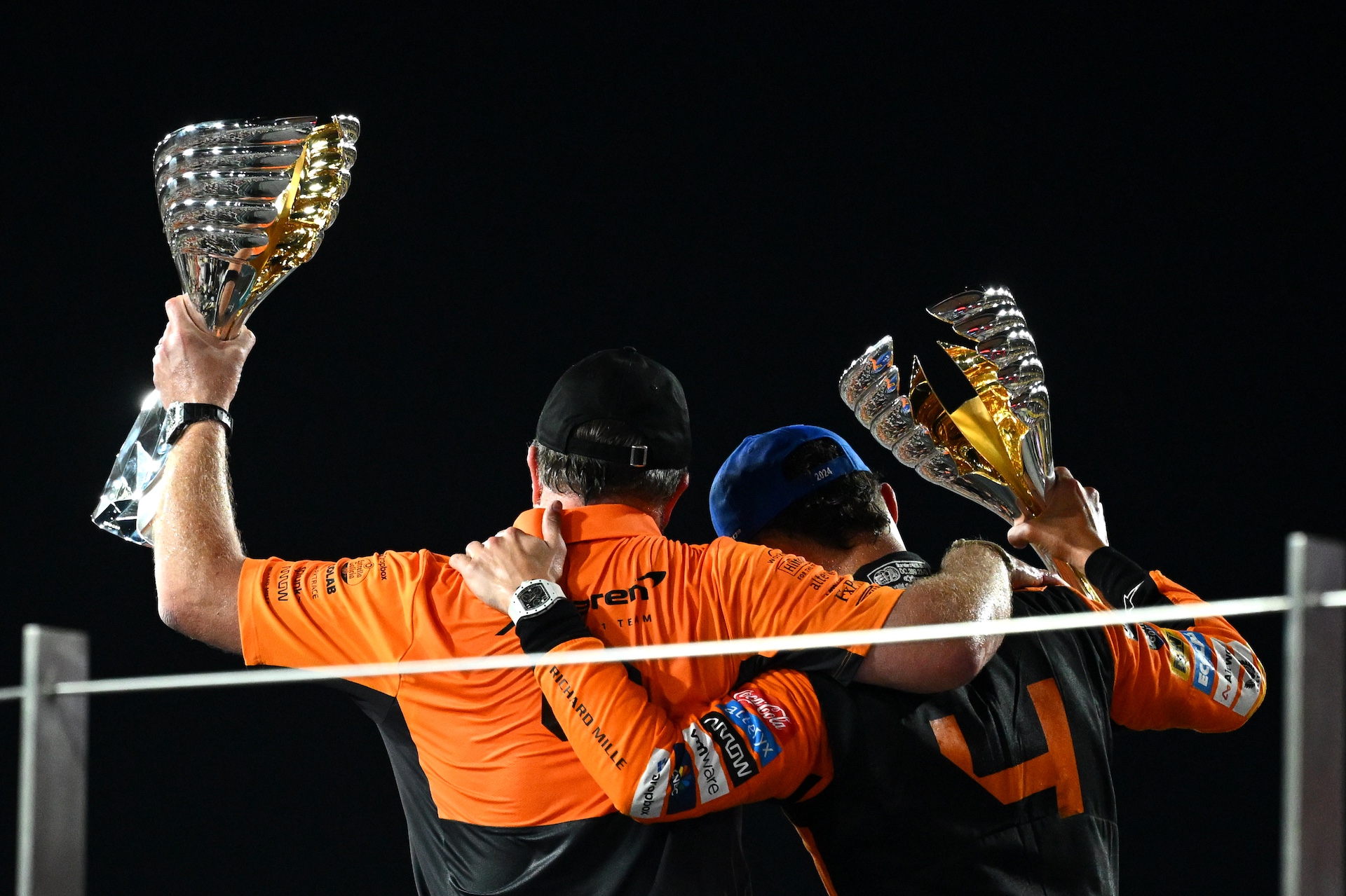 ABU DHABI, UNITED ARAB EMIRATES - DECEMBER 08: Race winner Lando Norris of Great Britain and McLaren and McLaren Chief Executive Officer Zak Brown celebrate on the podium after the McLaren team won the 2024 F1 Constructors Championship during the F1 Grand Prix of Abu Dhabi at Yas Marina Circuit on December 08, 2024 in Abu Dhabi, United Arab Emirates. (Photo by Clive Mason/Getty Images)