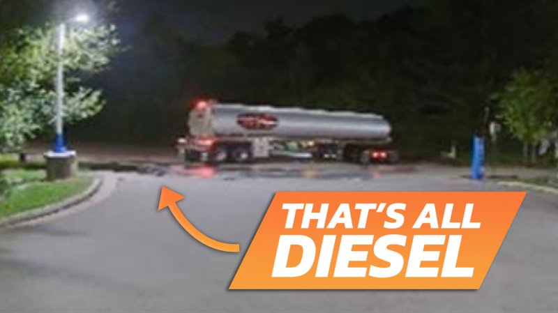 Security camera image of diesel tanker truck surrounded in diesel on the ground from a security camera, with the text "That's All Diesel" superimposed, and an arrow pointing to the giant puddle.